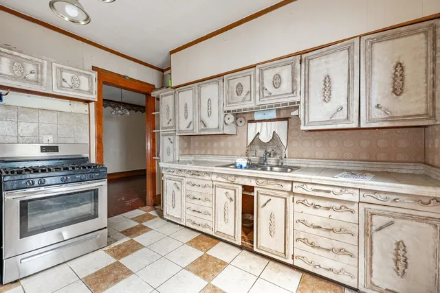 a kitchen with stainless steel appliances granite countertop a stove and cabinets