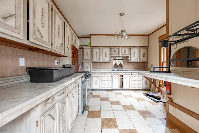 a kitchen with stainless steel appliances granite countertop a sink and a stove