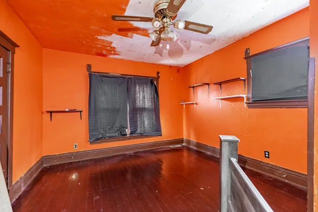 wooden floor in an empty room with a window