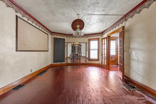 a view of a room with wooden floor and large window