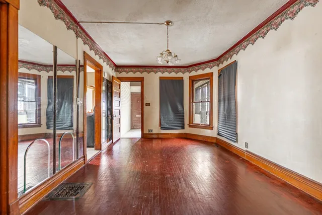 a view of a room with wooden floor and windows