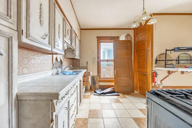 a kitchen with a sink stove and cabinets