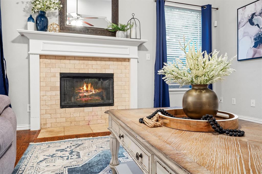 1501 Valley Creek Road Denton, TX 76205 - Photo 11 of 40 a living room with a fireplace and potted plant