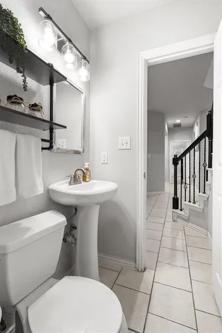 a white toilet sitting next to a bathroom sink
