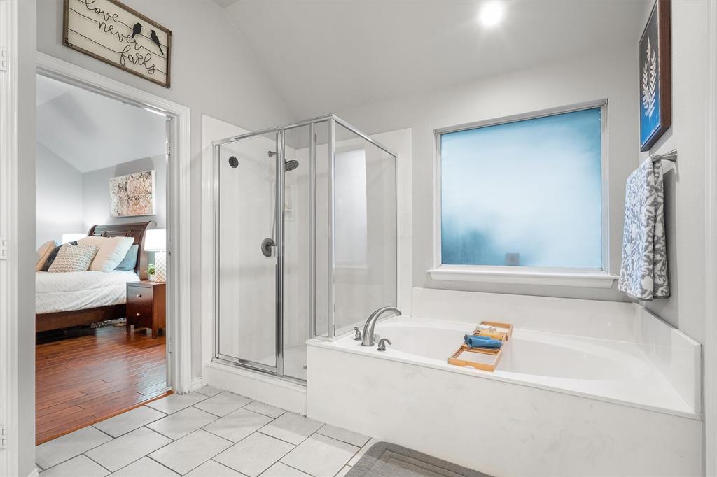 1501 Valley Creek Road Denton, TX 76205 - Photo 20 of 40 a bathroom with a tub a rug and a shower
