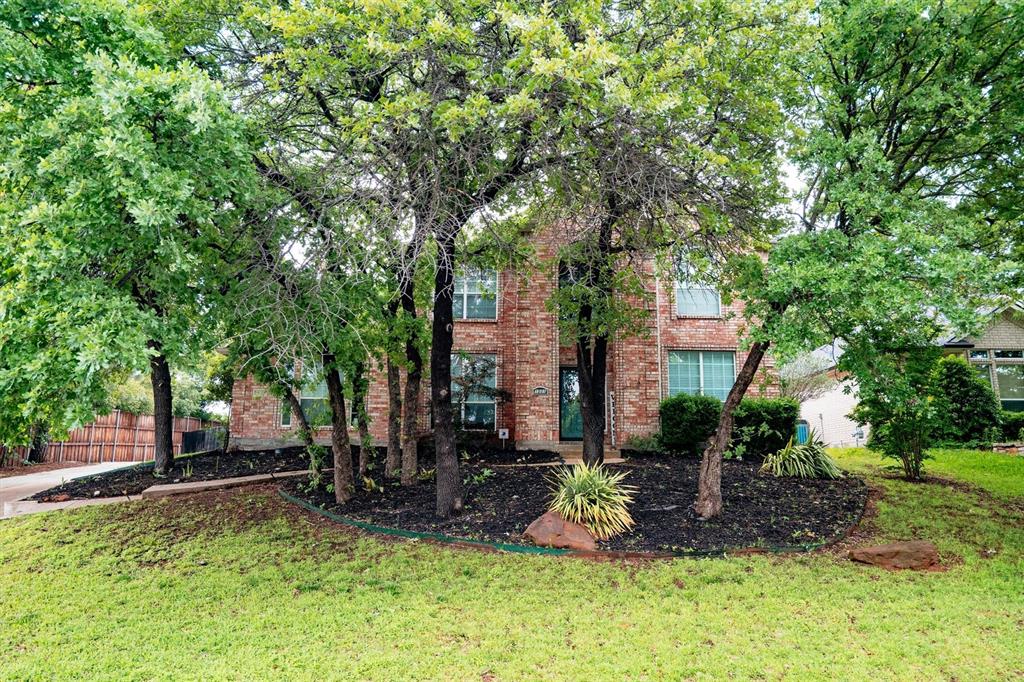 1501 Valley Creek Road Denton, TX 76205 - Photo 2 of 40 a front view of a house with a yard table and chairs