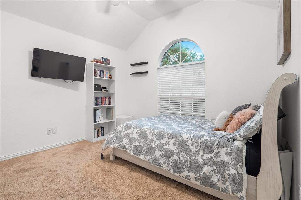 1501 Valley Creek Road Denton, TX 76205 - Photo 25 of 40 a bedroom with a bed and a flat screen tv