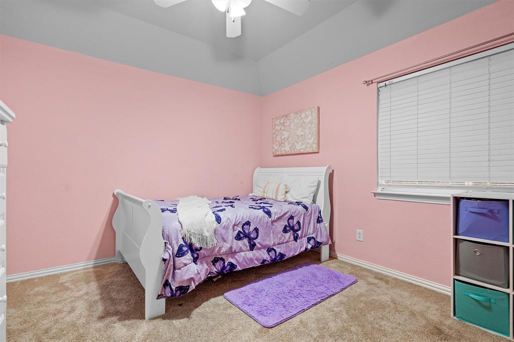 1501 Valley Creek Road Denton, TX 76205 - Photo 28 of 40 a bed room with a bed and a dresser
