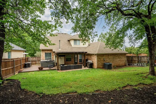 a view of a house with a yard and sitting area
