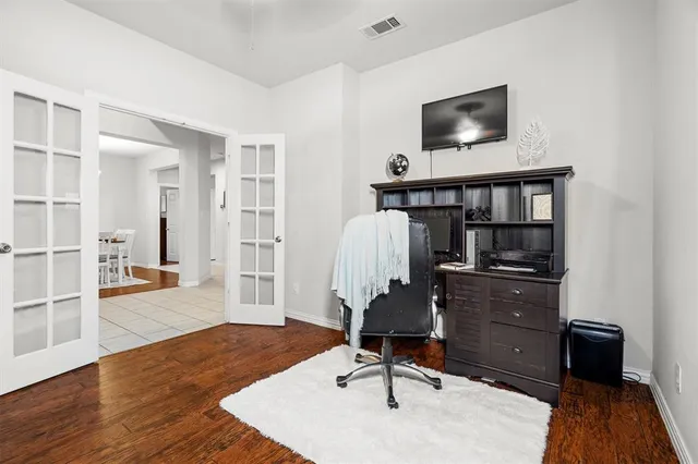 a view of a workspace with furniture and wooden floor