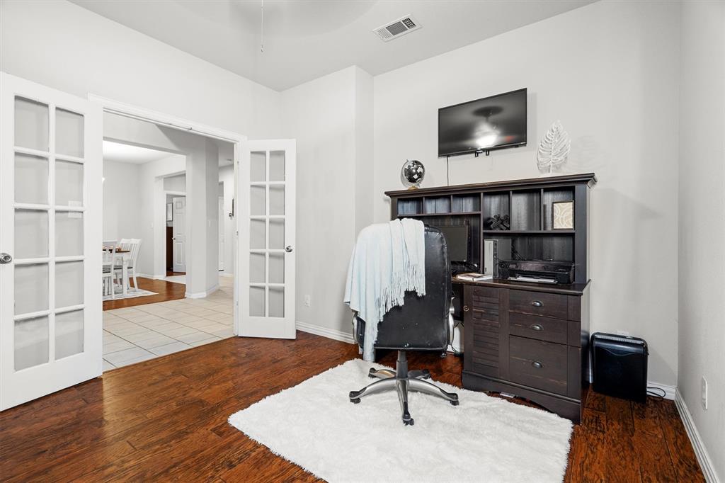 1501 Valley Creek Road Denton, TX 76205 - Photo 8 of 40 a view of a workspace with furniture and wooden floor