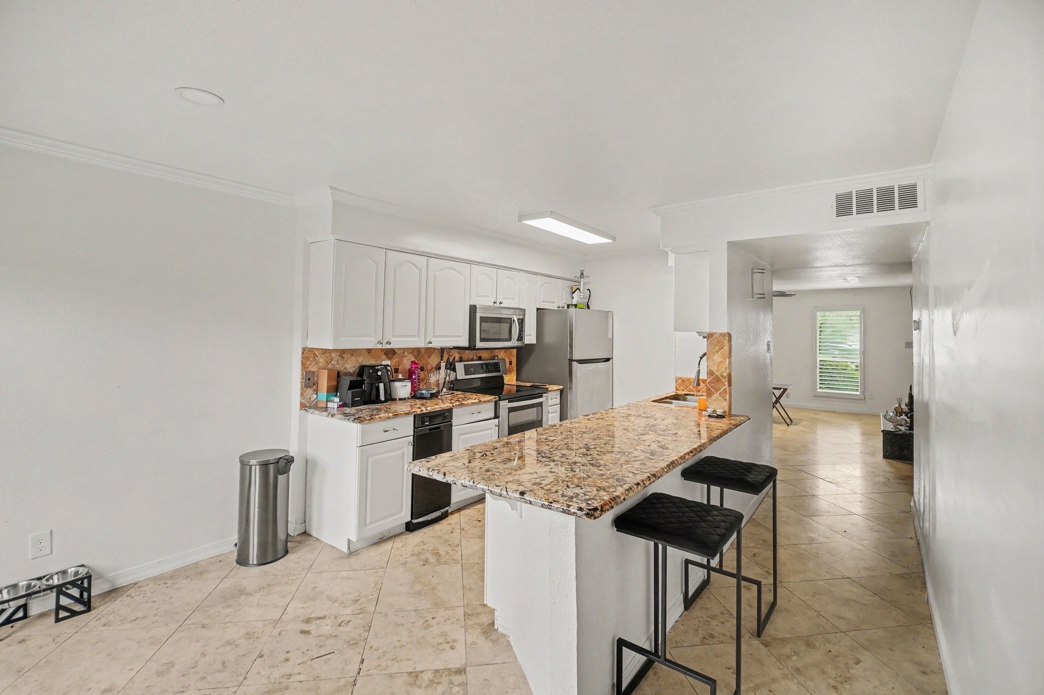 5801 Lumberdale Road, Unit 78 Houston, TX 77092 - Photo 7 of 35 Experience culinary elegance in a kitchen featuring sleek granite counters, perfect for entertaining and everyday living.