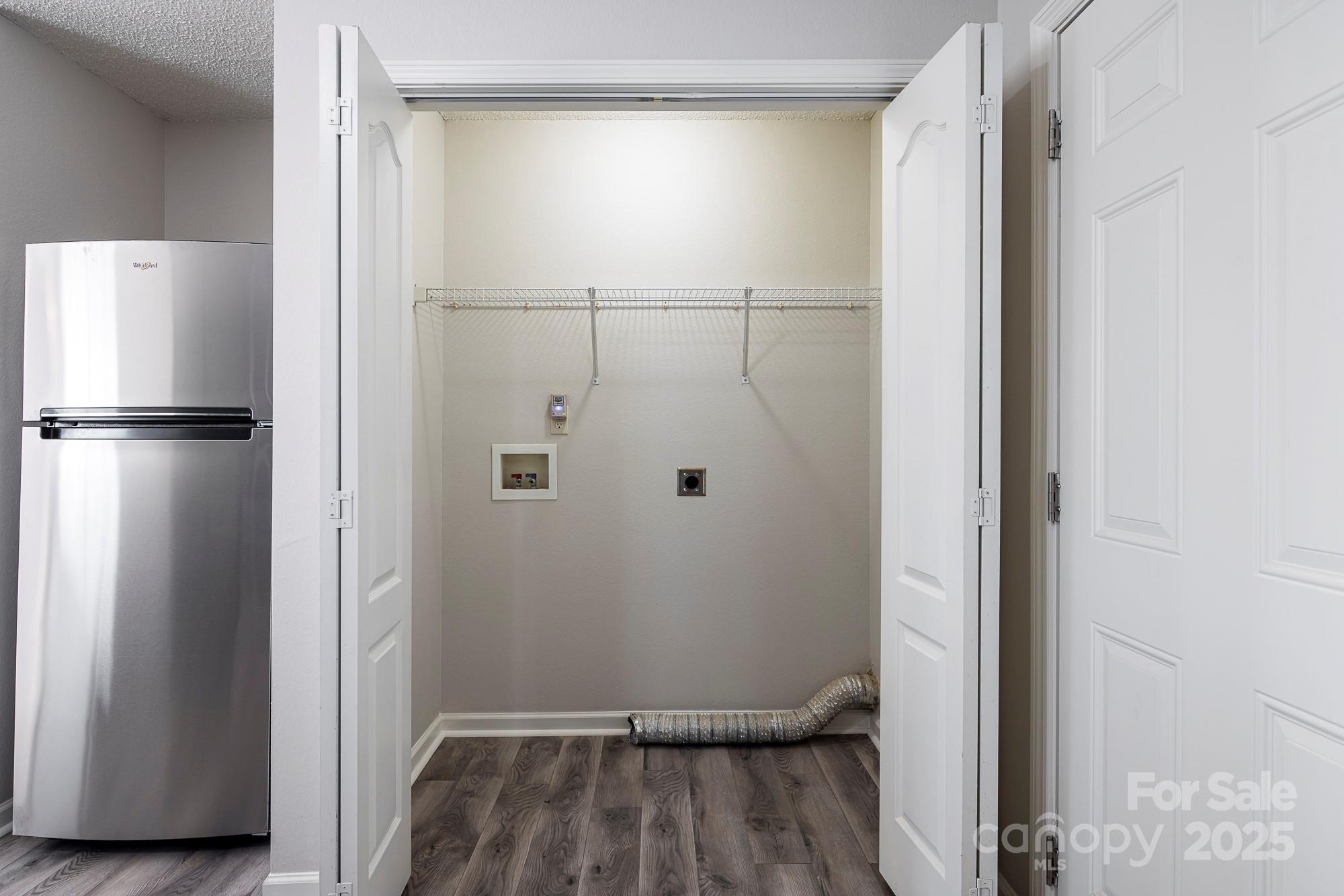 162 None Road Columbia, SC 29223 - Photo 11 of 24 a view of a refrigerator and wooden floor