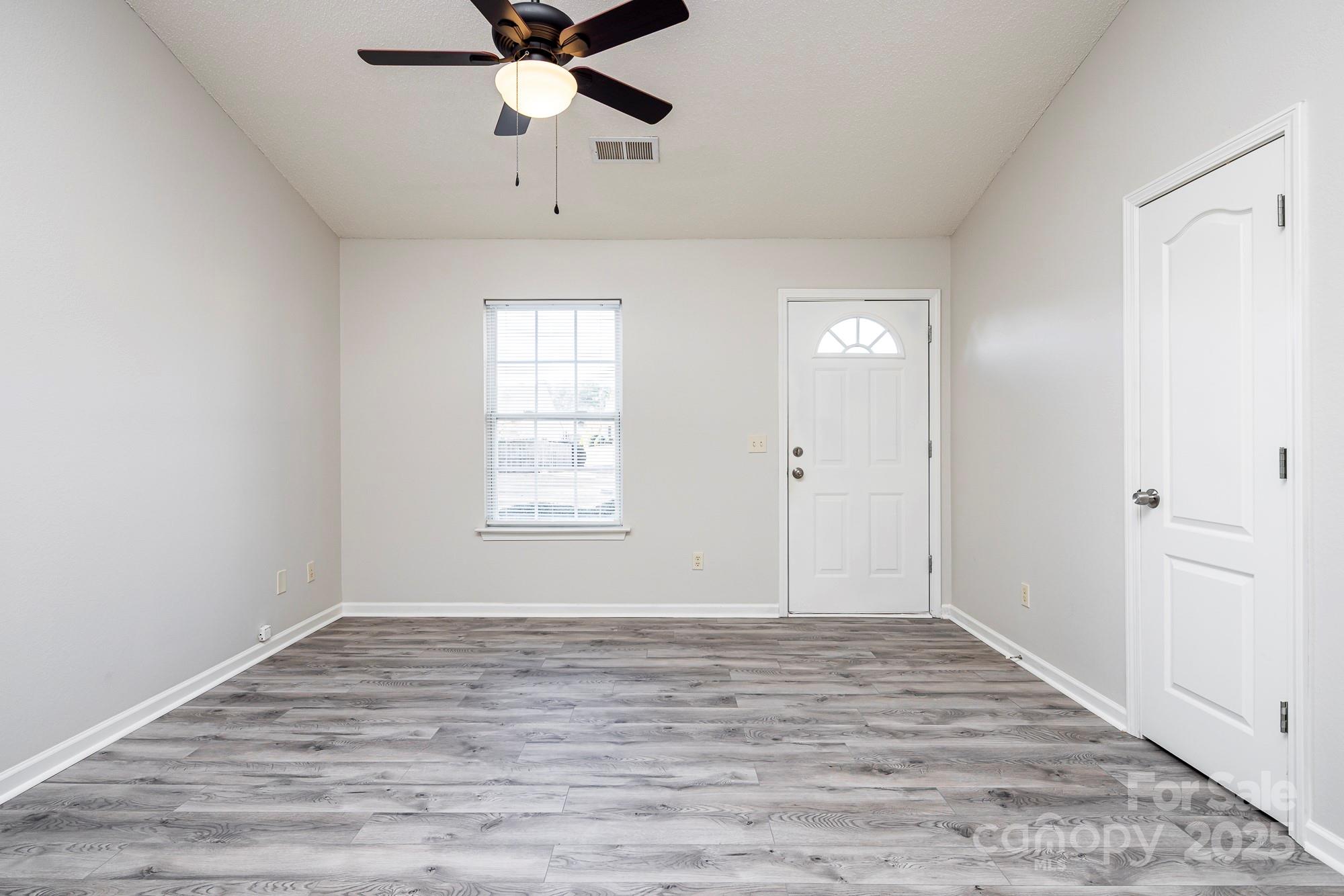 162 None Road Columbia, SC 29223 - Photo 3 of 24 wooden floor in an empty room with a window