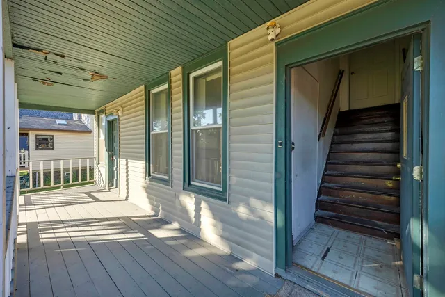 a view of a house with swimming pool and a porch