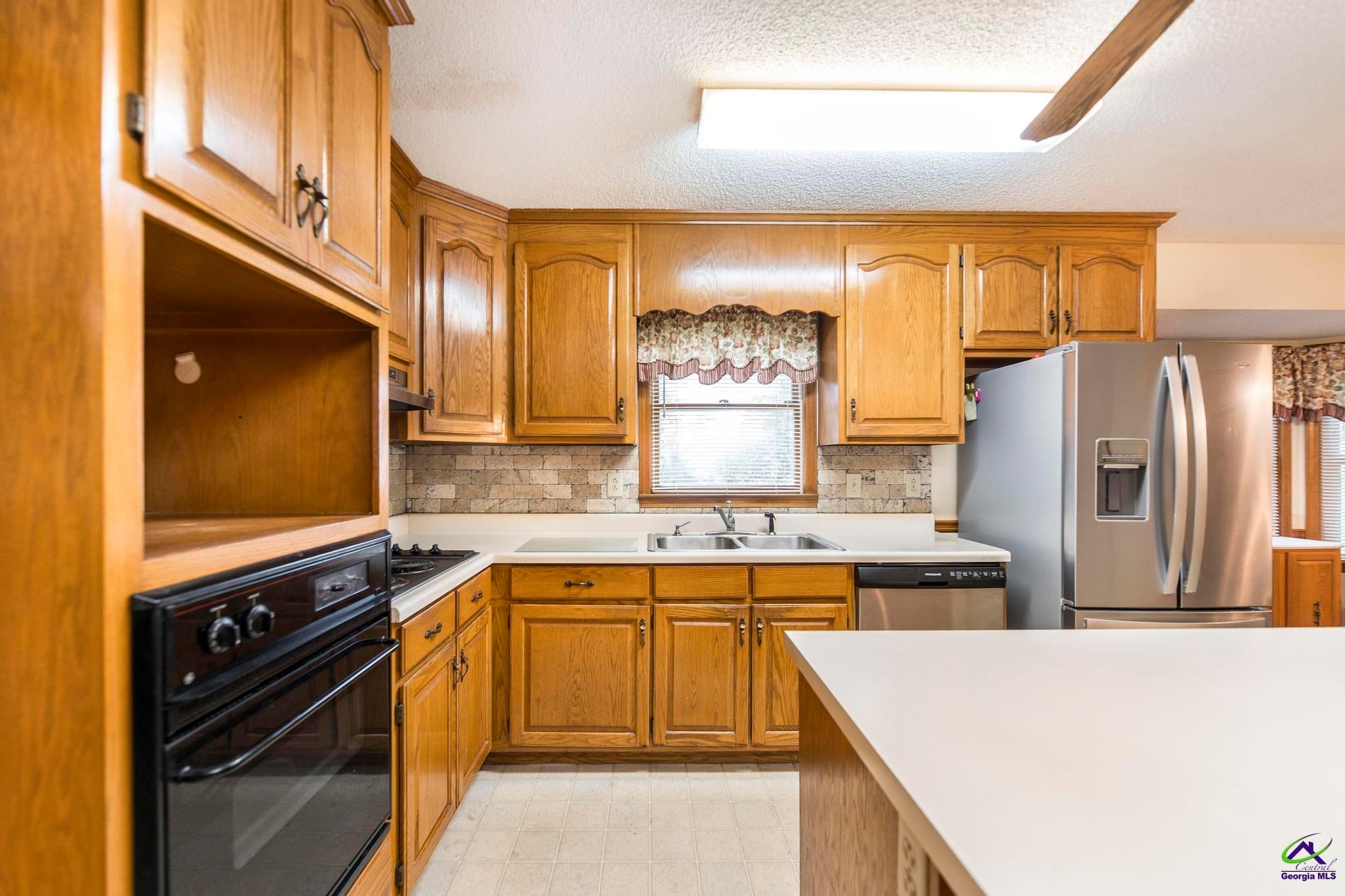 5731 School Road Macon, GA 31216 - Photo 10 of 33 Generous counter space and cabinetry for all your needs.