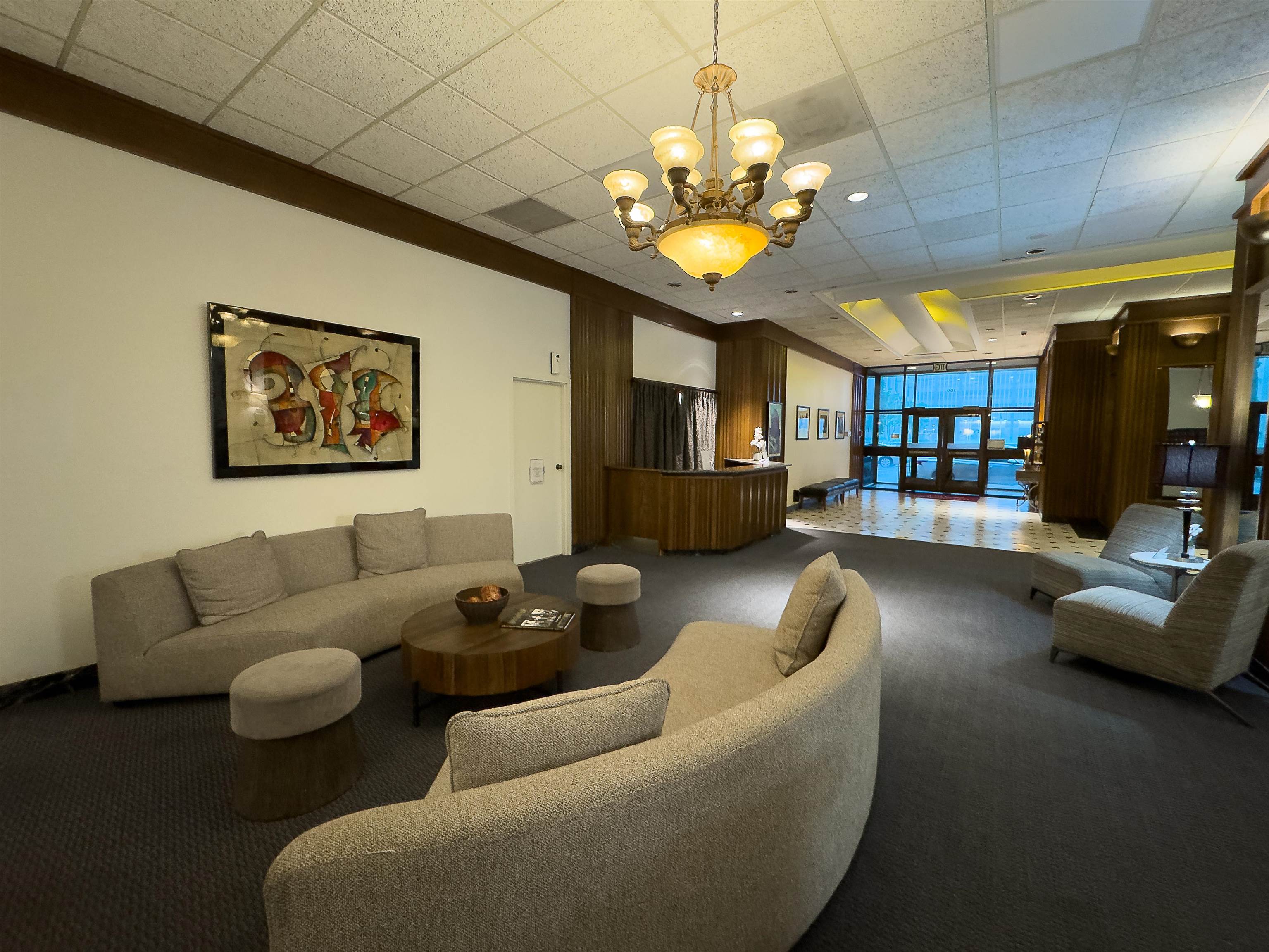 109 North Main Street, Unit 907 Memphis, TN 38103 - Photo 3 of 29 Lobby area featuring wood paneling, recessed lighting, and a prominent chandelier