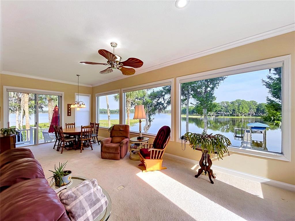 1360 South Waterview Drive Inverness, FL 34450 - Photo 40 of 100 a living room with furniture and floor to ceiling windows