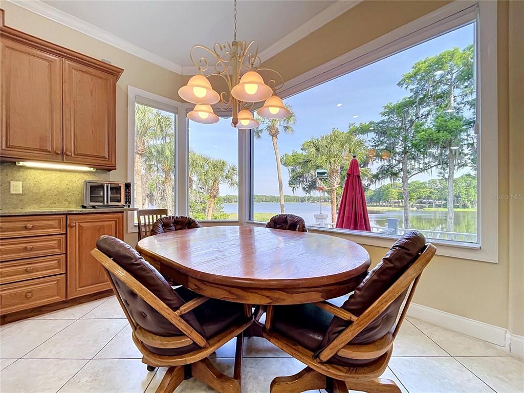 1360 South Waterview Drive Inverness, FL 34450 - Photo 47 of 100 a dining room with furniture a chandelier and wooden floor