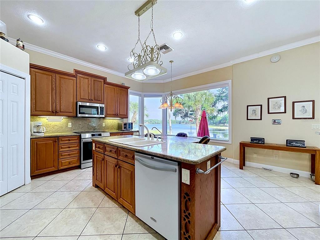 1360 South Waterview Drive Inverness, FL 34450 - Photo 52 of 100 a kitchen with stainless steel appliances granite countertop a sink and a refrigerator