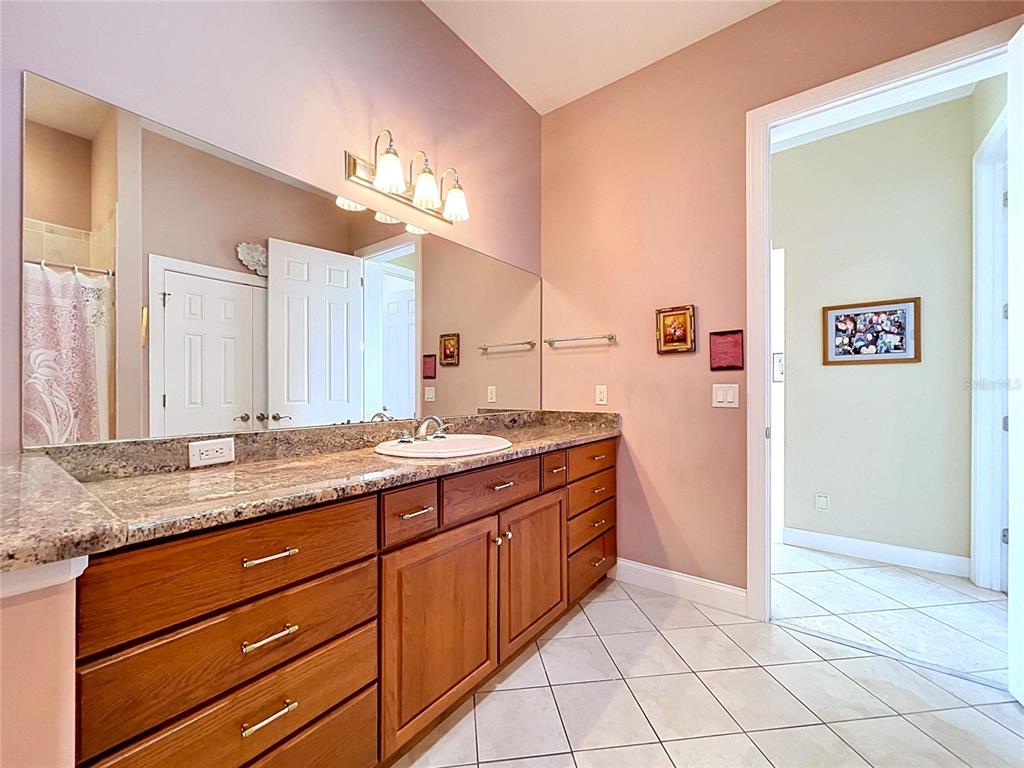 1360 South Waterview Drive Inverness, FL 34450 - Photo 61 of 100 a bathroom with a granite countertop double vanity sink and a mirror