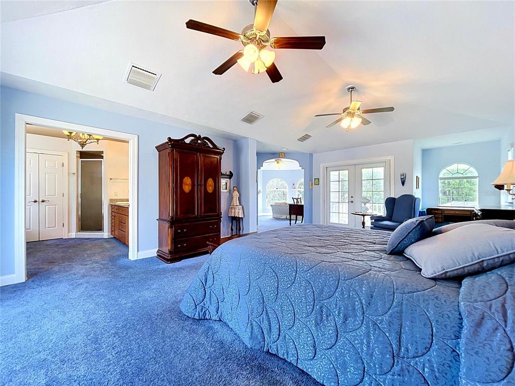 1360 South Waterview Drive Inverness, FL 34450 - Photo 78 of 100 a bedroom with a bed and a chandelier