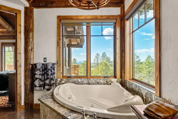a bathroom with a tub and window