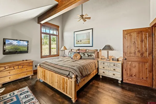 a bedroom with a bed and a dresser