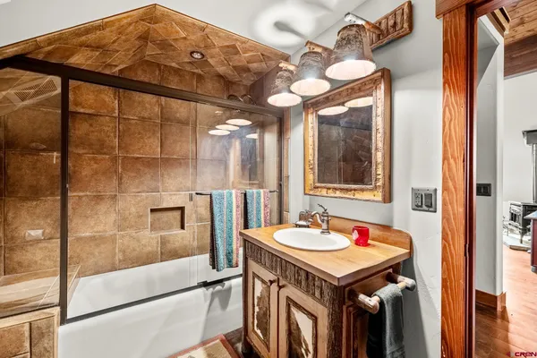 a bathroom with a sink a mirror and a shower
