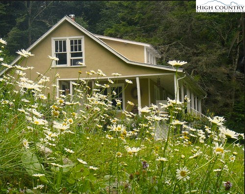 300 Little Horse Trail Road Lansing, NC 28643 - Photo 1 of 16 a front view of house with yard and green space