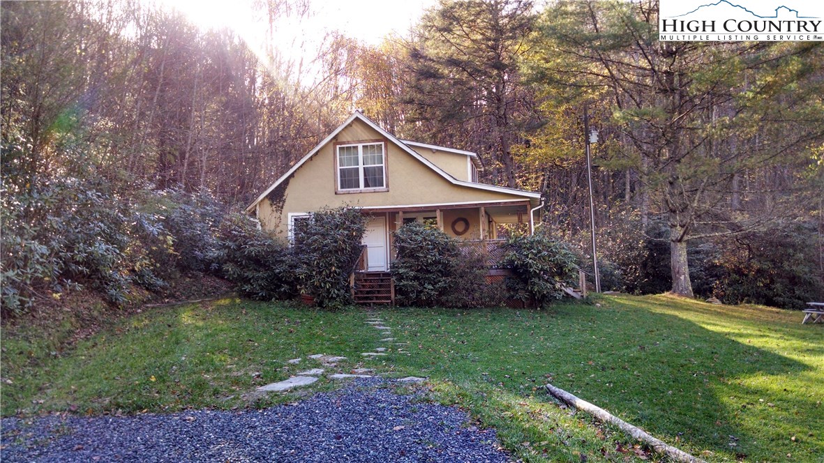 300 Little Horse Trail Road Lansing, NC 28643 - Photo 3 of 16 a front view of a house with a yard and trees