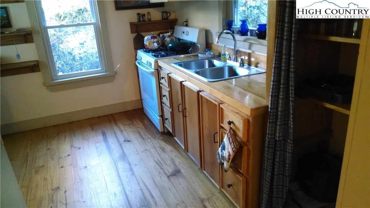 300 Little Horse Trail Road Lansing, NC 28643 - Photo 5 of 16 a kitchen with stove and wooden floor