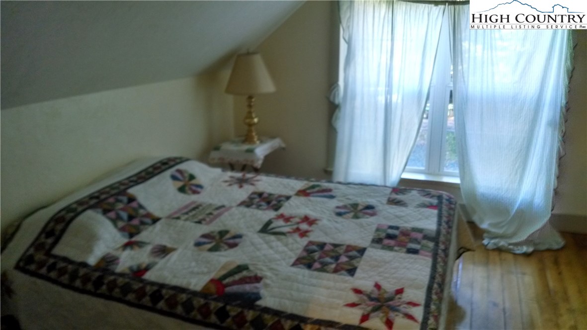 300 Little Horse Trail Road Lansing, NC 28643 - Photo 7 of 16 a bed in a bedroom next to a window