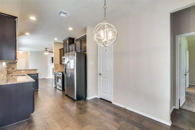 a view of a kitchen with a sink stainless steel appliances and cabinets