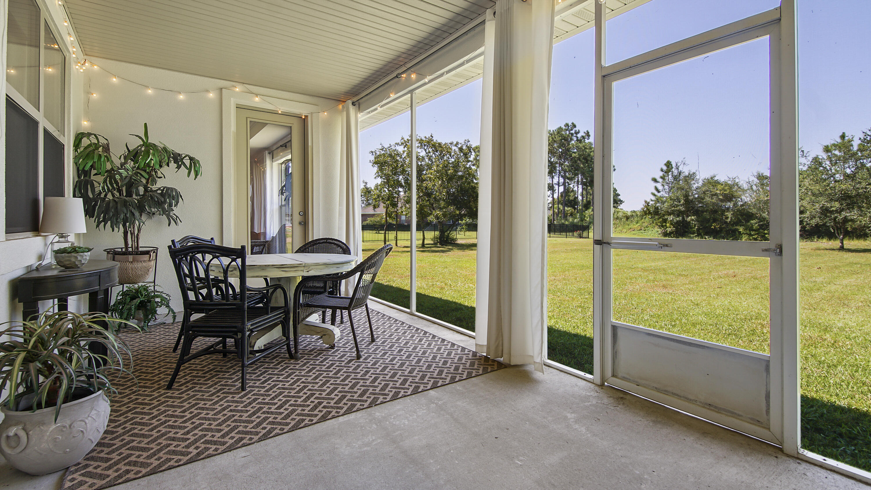 1464 Brushed Dune Circle Freeport, FL 32439 - Photo 39 of 62 a view of a patio with table and chairs and potted plants