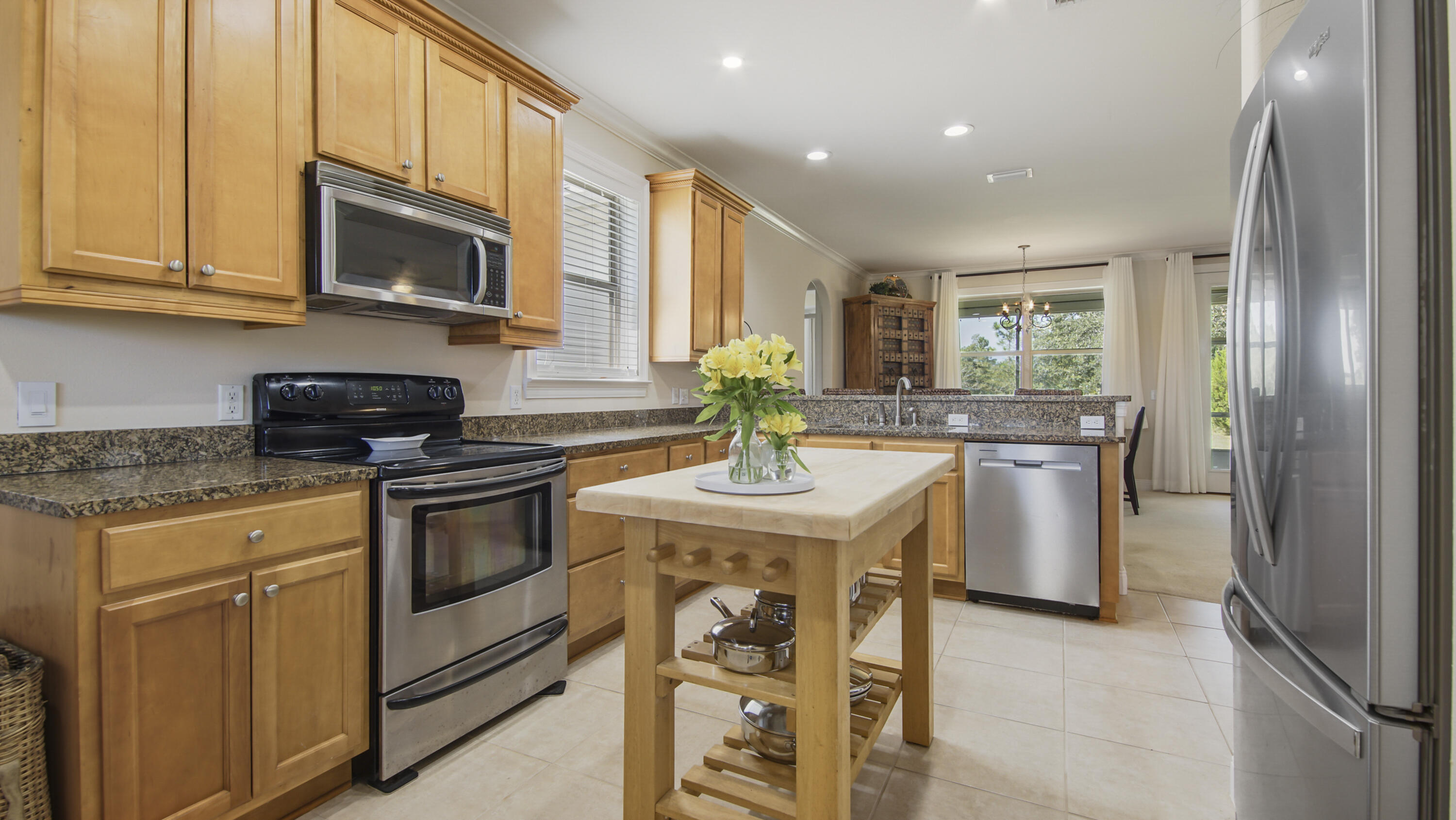 1464 Brushed Dune Circle Freeport, FL 32439 - Photo 7 of 62 a kitchen with granite countertop a sink stove and microwave