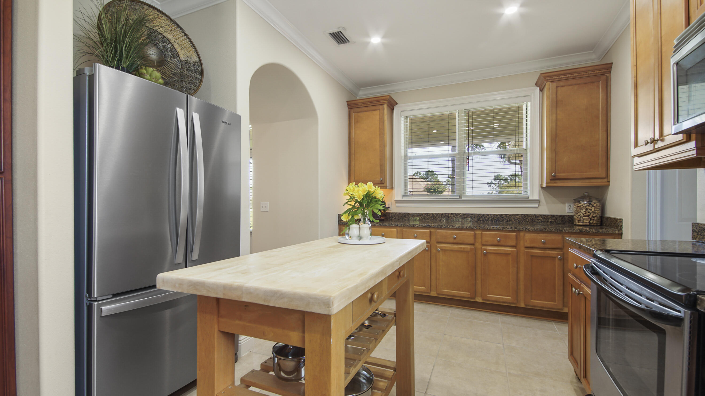 1464 Brushed Dune Circle Freeport, FL 32439 - Photo 10 of 62 a kitchen with stainless steel appliances granite countertop a refrigerator a sink a stove and island