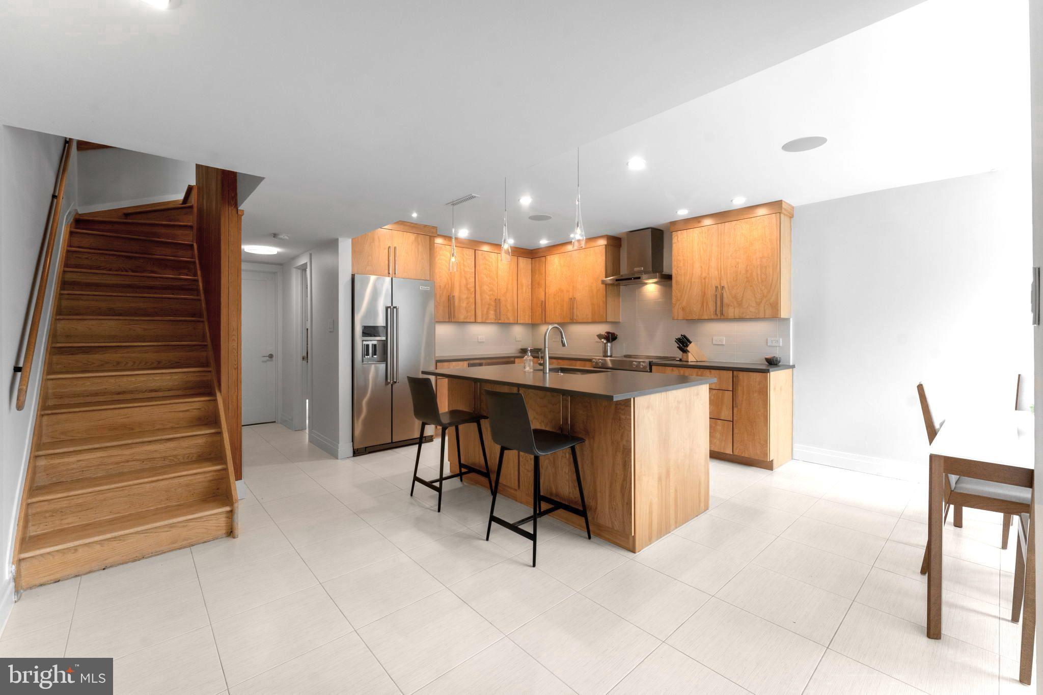 11587 Maple Ridge Road Reston, VA 20190 - Photo 11 of 119 a room with stainless steel appliances kitchen island granite countertop furniture and a view of living room