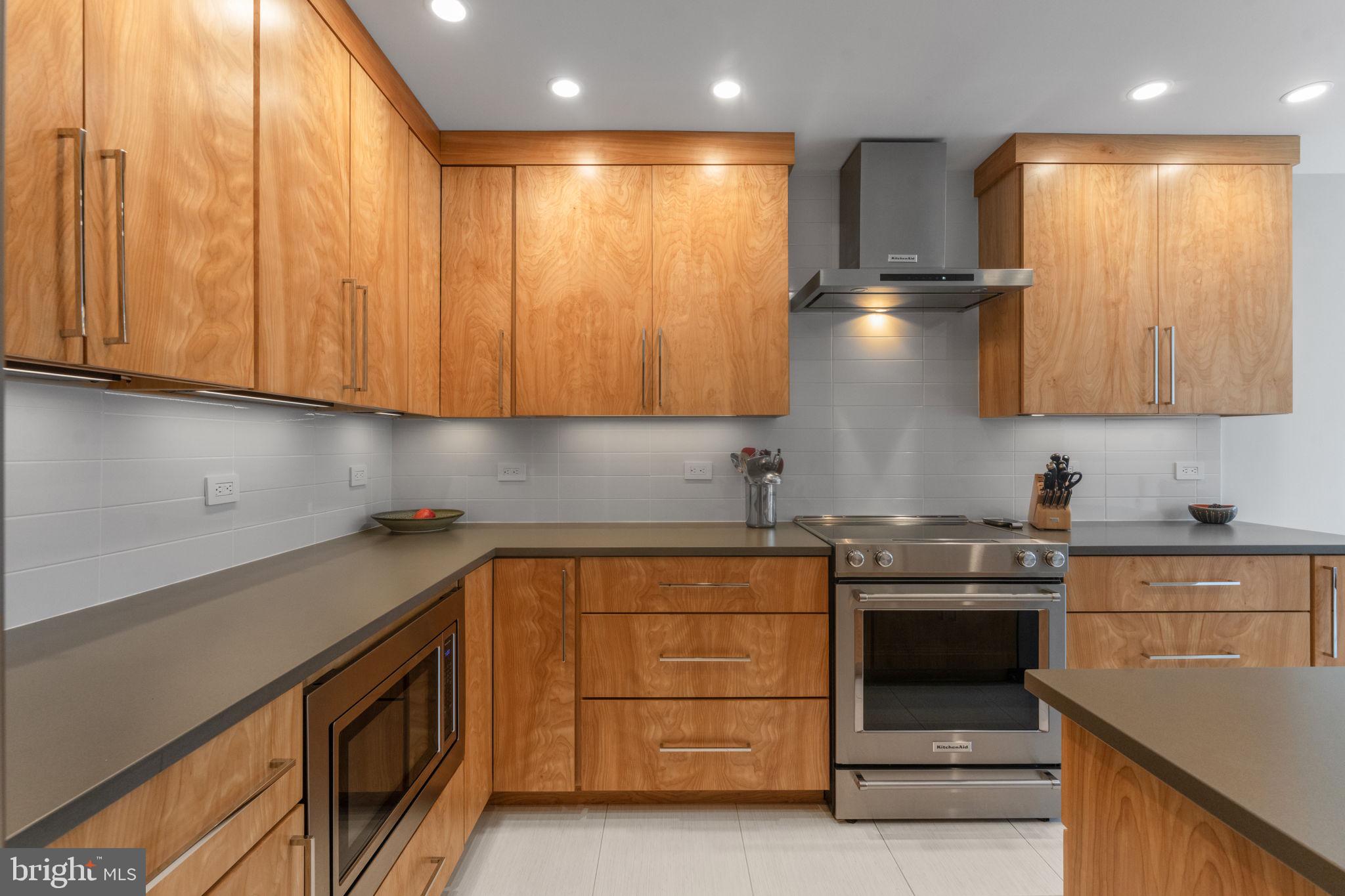 11587 Maple Ridge Road Reston, VA 20190 - Photo 14 of 119 a kitchen with stainless steel appliances granite countertop a sink and a stove