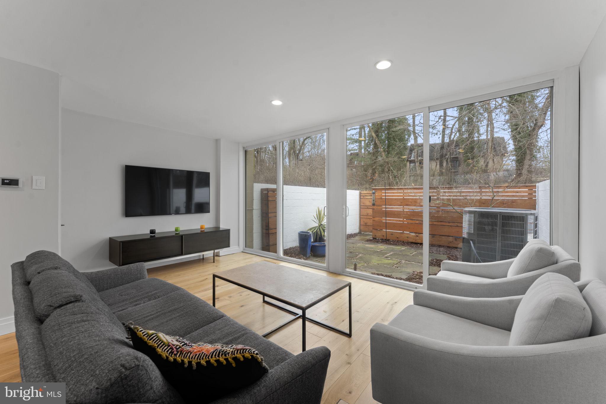 11587 Maple Ridge Road Reston, VA 20190 - Photo 26 of 119 a living room with furniture and a flat screen tv