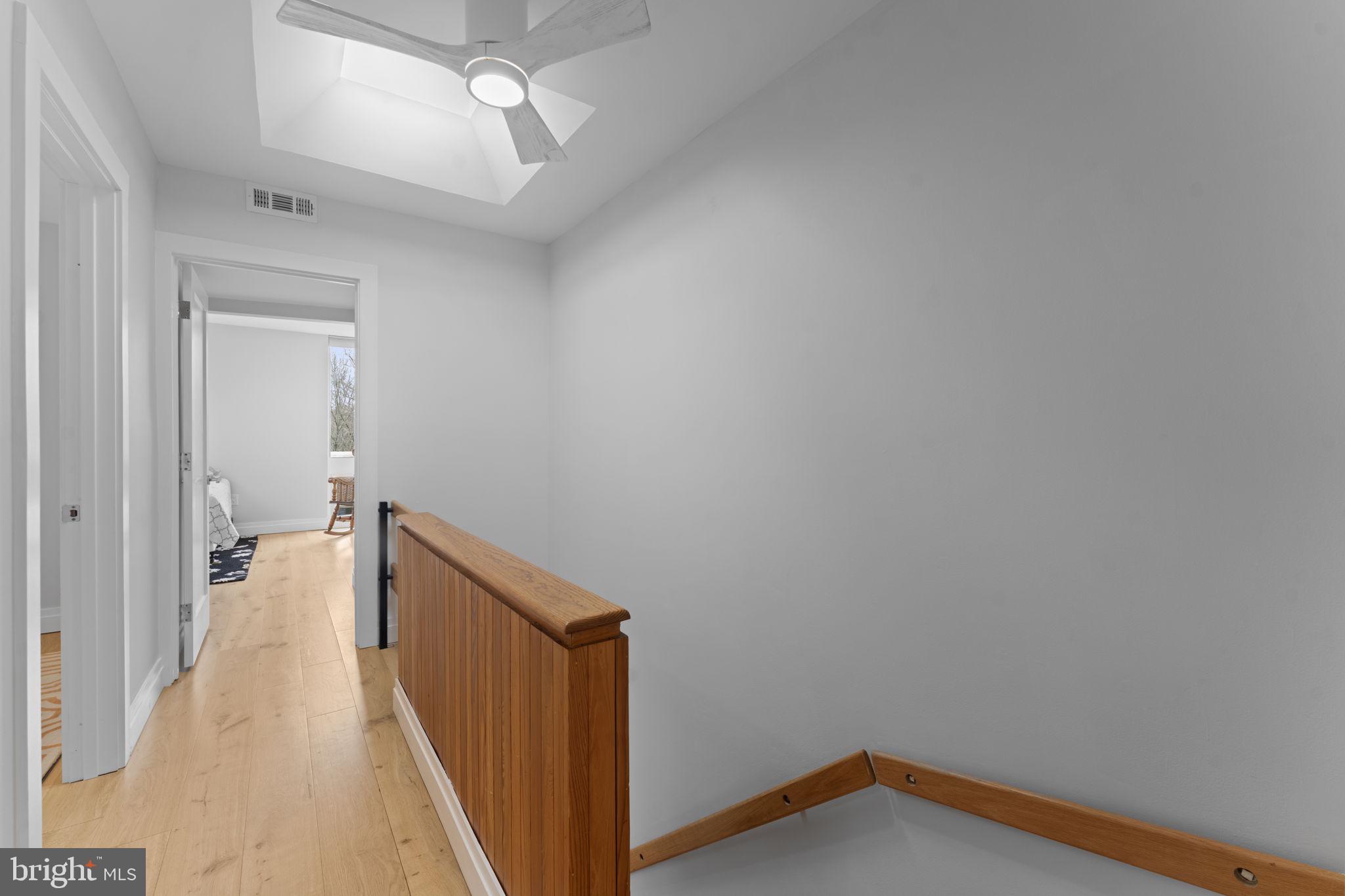 11587 Maple Ridge Road Reston, VA 20190 - Photo 33 of 119 a view of a hallway with wooden floor and a chandelier