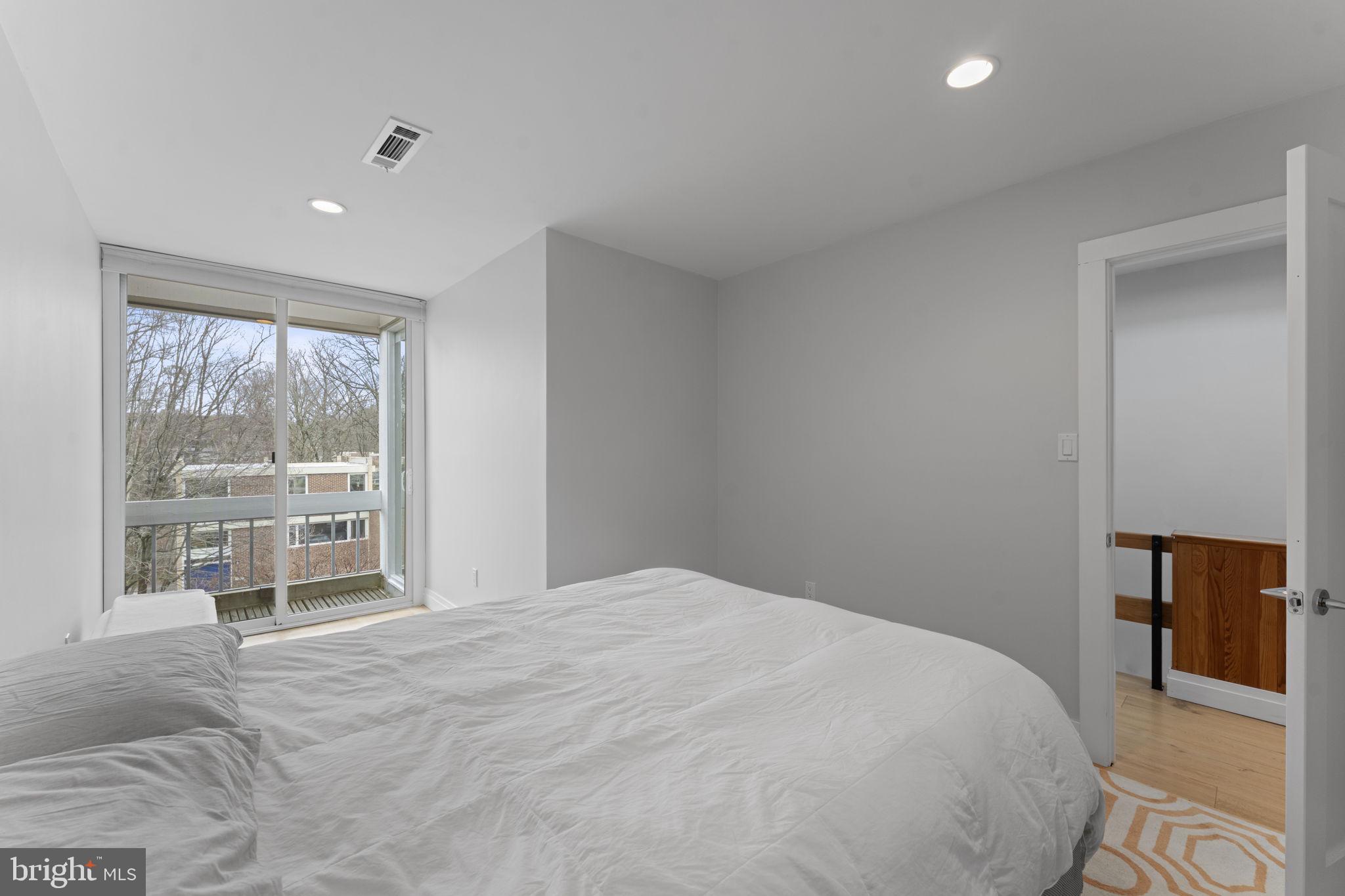 11587 Maple Ridge Road Reston, VA 20190 - Photo 37 of 119 a bedroom with a large bed and a large window