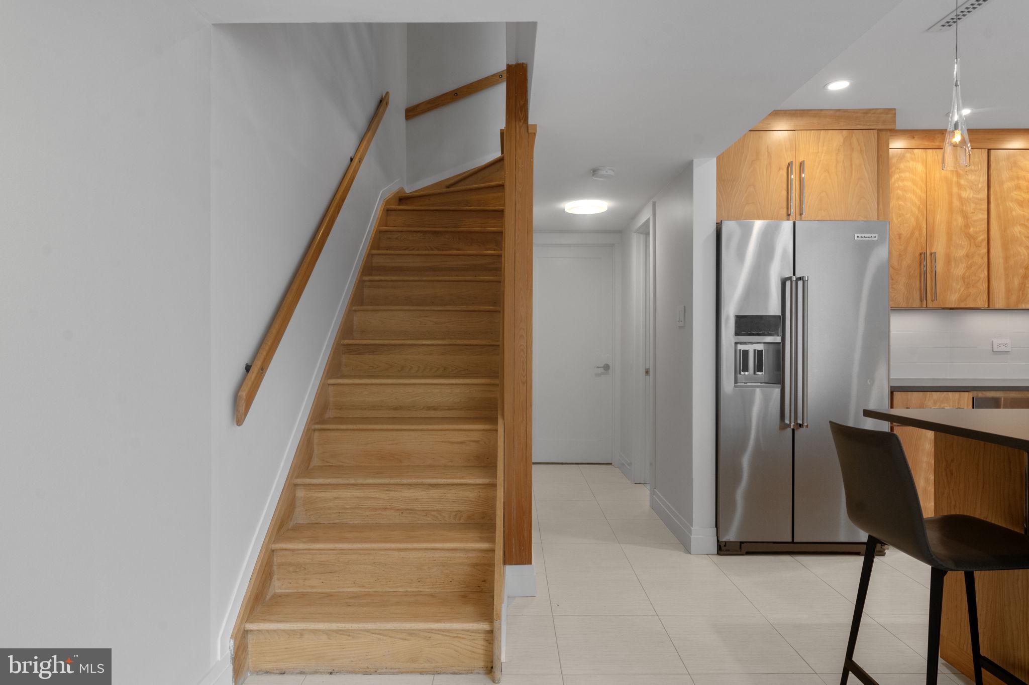 11587 Maple Ridge Road Reston, VA 20190 - Photo 55 of 119 a view of a hallway with entryway wooden floor and front door
