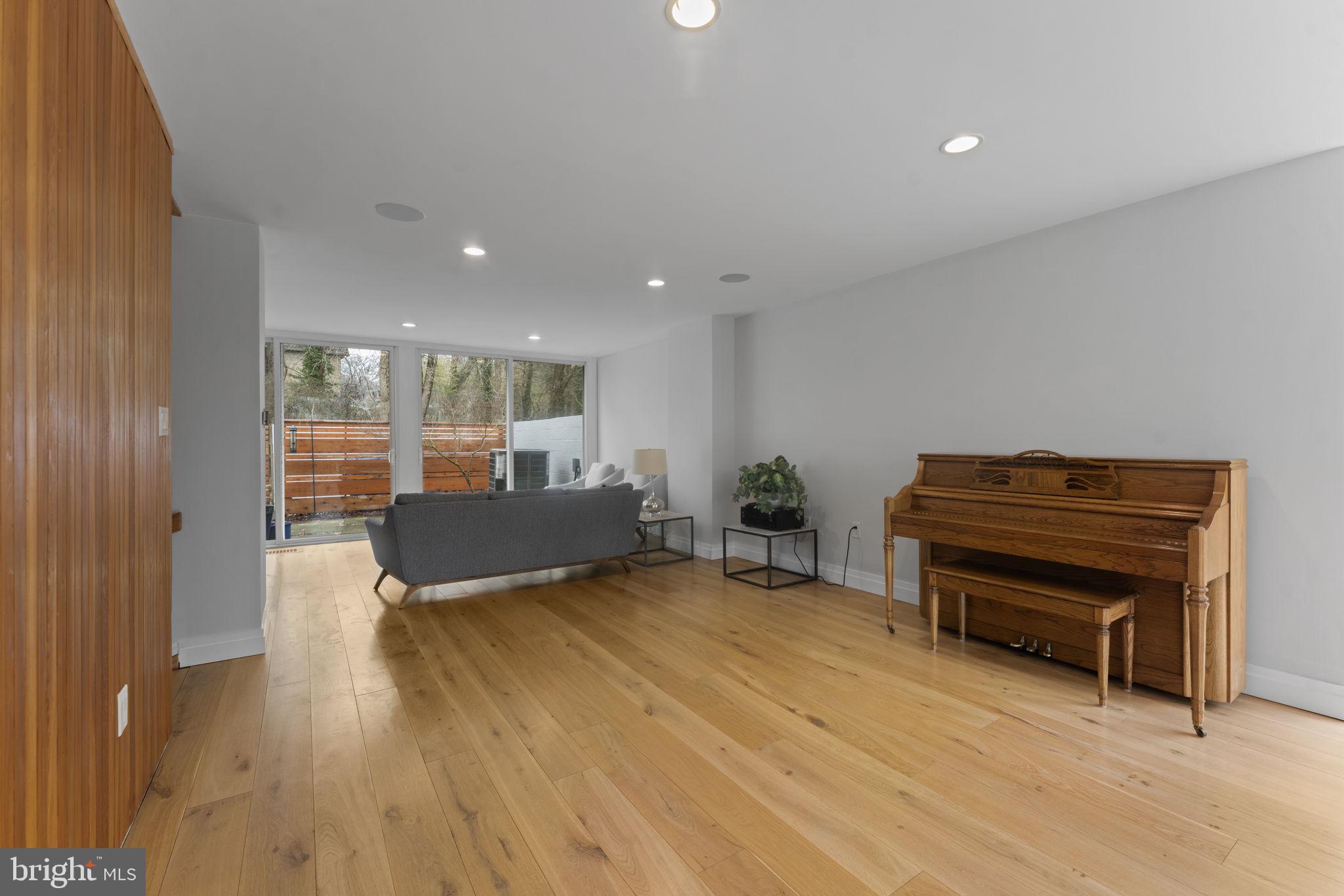 11587 Maple Ridge Road Reston, VA 20190 - Photo 57 of 119 a living room with furniture and a piano