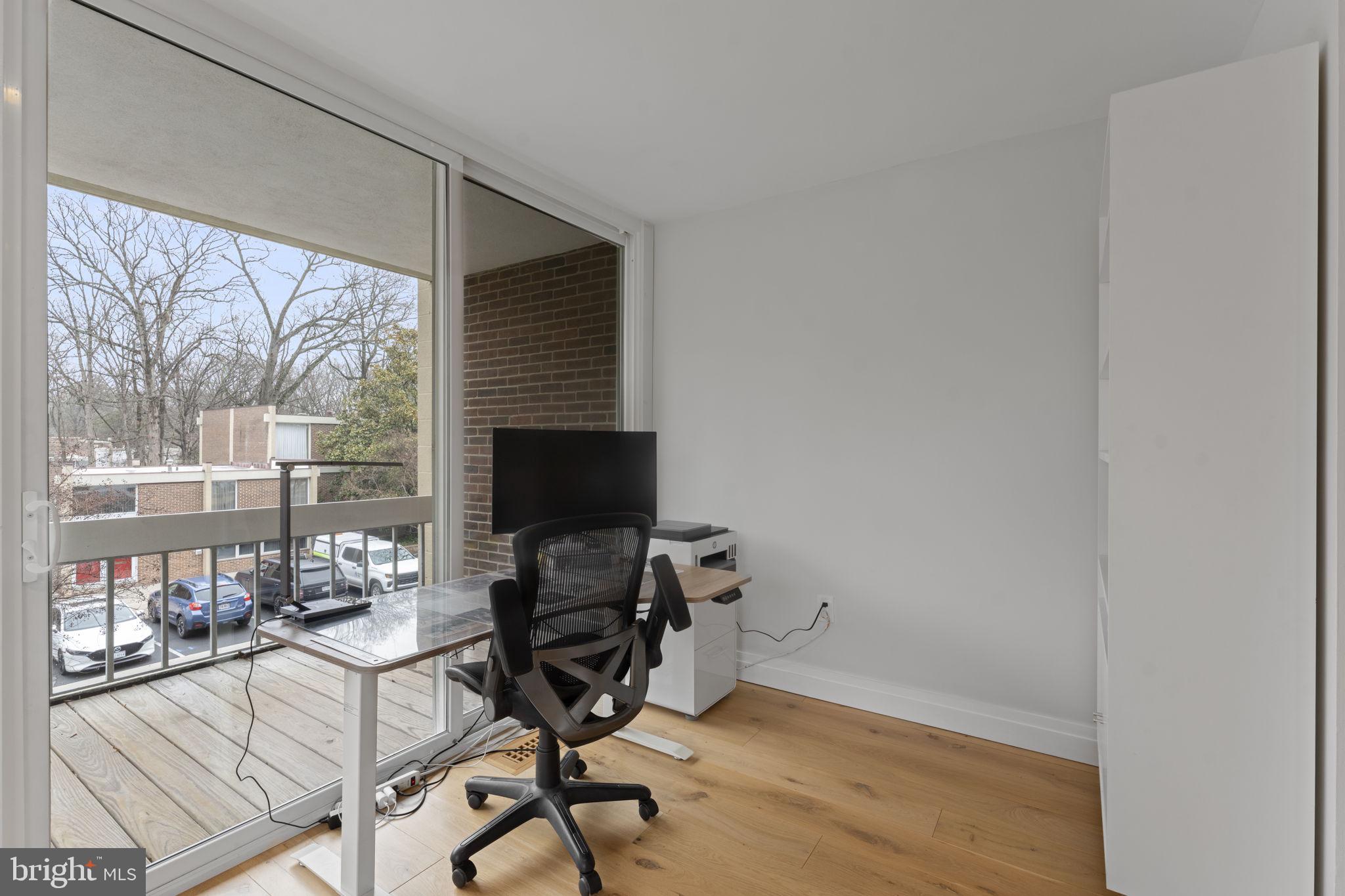 11587 Maple Ridge Road Reston, VA 20190 - Photo 58 of 119 a view of a workspace with furniture and a gate
