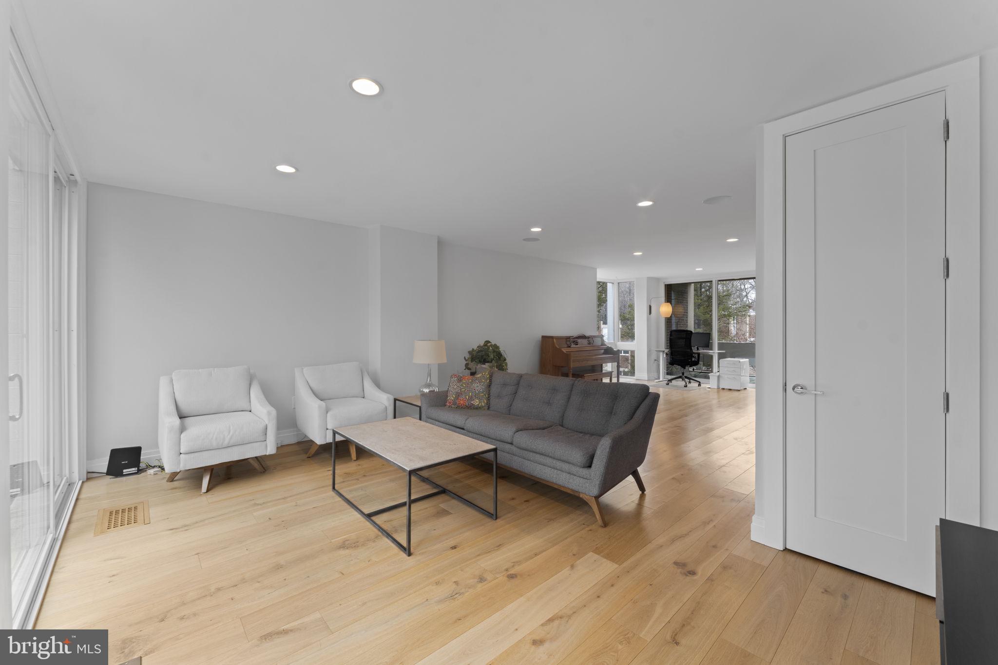 11587 Maple Ridge Road Reston, VA 20190 - Photo 62 of 119 a living room with furniture and a table with wooden floor