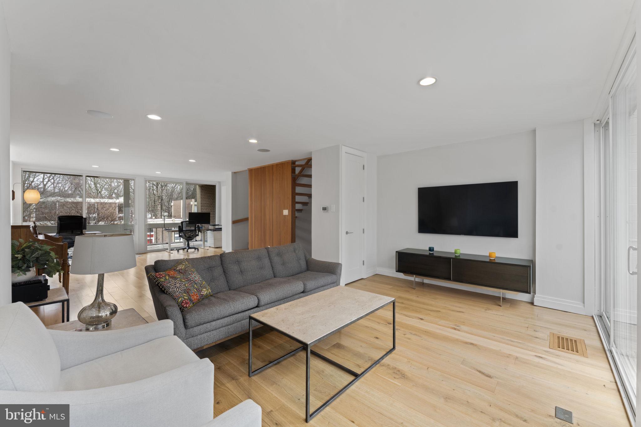 11587 Maple Ridge Road Reston, VA 20190 - Photo 64 of 119 a living room with furniture and a flat screen tv