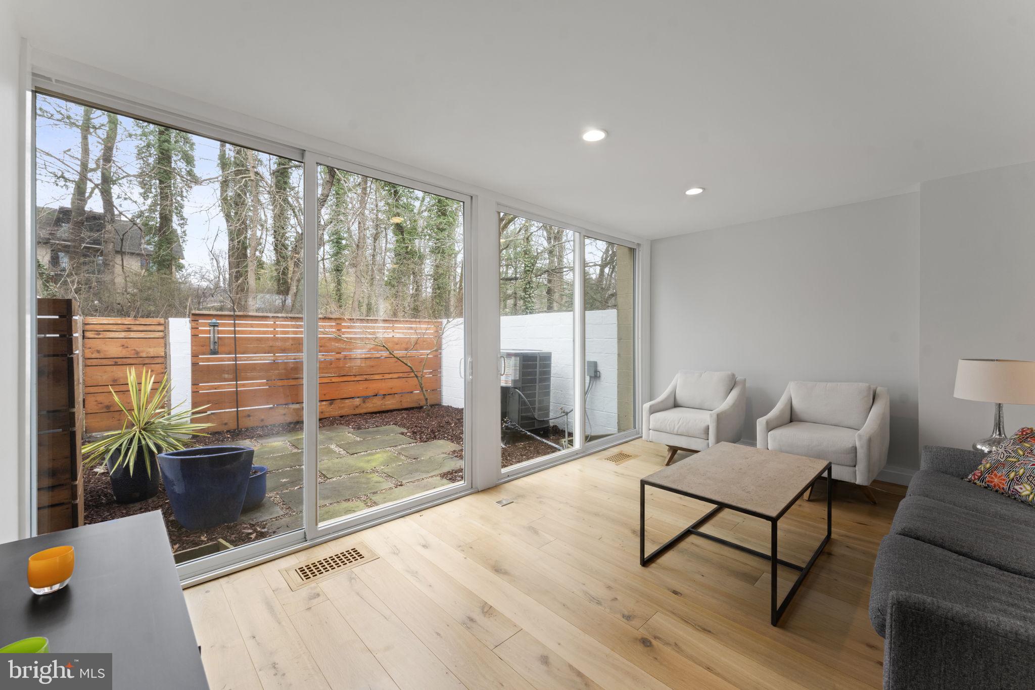 11587 Maple Ridge Road Reston, VA 20190 - Photo 65 of 119 a living room with furniture and a floor to ceiling window