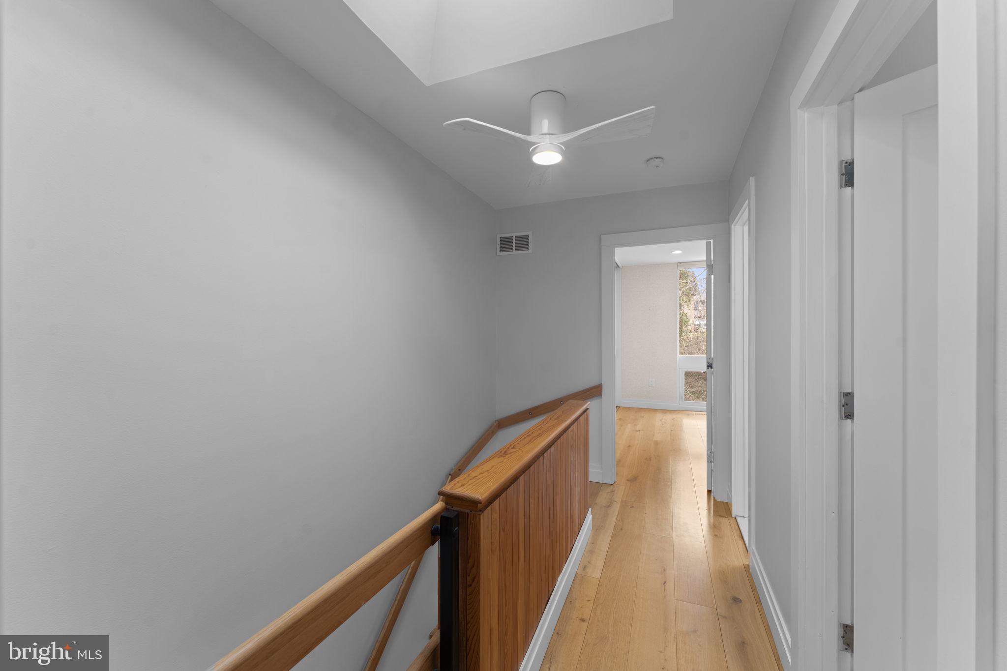 11587 Maple Ridge Road Reston, VA 20190 - Photo 77 of 119 a view of a hallway with wooden floor