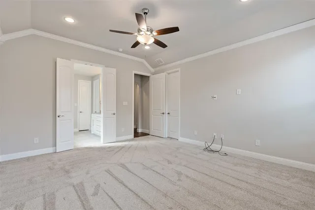 an empty room with ceiling fan and window
